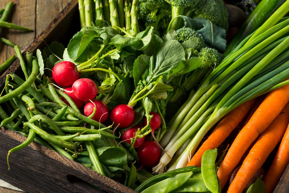 Raw Organic Spring Vegetables in a Farmers Market Box